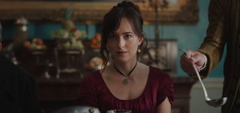 Movie still from “Persuasion” (2022), directed by Carrie Cracknell – A woman sitting at a table with a bowl in front of her; Close Up shot, Over the shoulder angle