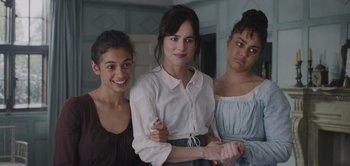Movie still from “Persuasion” (2022), directed by Carrie Cracknell – A group of young women standing next to each other; Medium shot, Over the shoulder angle