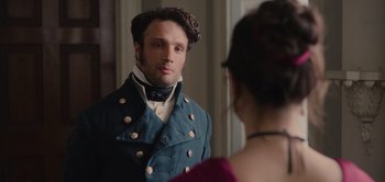 Movie still from “Persuasion” (2022), directed by Carrie Cracknell – A man in a blue jacket looking at a woman in a red dress; Close Up shot, Over the shoulder angle