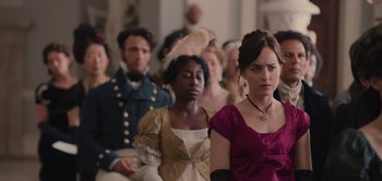 Movie still from “Persuasion” (2022), directed by Carrie Cracknell – A group of people sitting in front of each other; Close Up shot, Over the shoulder angle