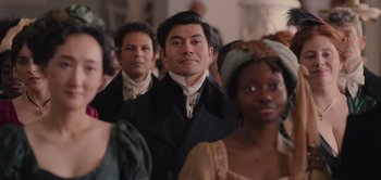 Movie still from “Persuasion” (2022), directed by Carrie Cracknell – A group of men and women standing next to each other; Medium shot, Over the shoulder angle