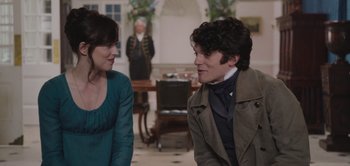 Movie still from “Persuasion” (2022), directed by Carrie Cracknell – A man and a woman talking to each other in a room; Medium shot, Over the shoulder angle