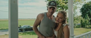 Movie still from “Pet Sematary: Bloodlines” (2023), directed by Lindsey Anderson Beer – A man and a woman posing for a picture; Medium shot, Over the shoulder angle