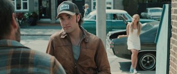 Movie still from “Pet Sematary: Bloodlines” (2023), directed by Lindsey Anderson Beer – A man in a baseball cap and a leather jacket; Close Up shot, Over the shoulder angle