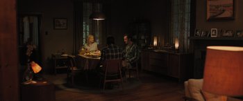 Movie still from “Pet Sematary: Bloodlines” (2023), directed by Lindsey Anderson Beer – A group of people sitting at a table in a room; Wide shot, High angle