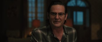 Movie still from “Pet Sematary: Bloodlines” (2023), directed by Lindsey Anderson Beer – A person wearing glasses and a shirt; Close Up shot, Over the shoulder angle