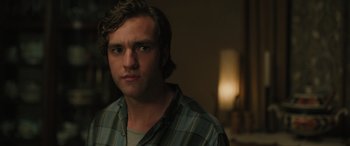 Movie still from “Pet Sematary: Bloodlines” (2023), directed by Lindsey Anderson Beer – A man with a beard is looking at the camera; Close Up shot, Over the shoulder angle