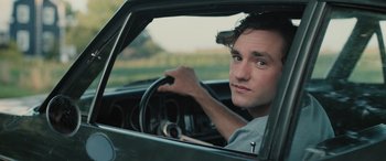 Movie still from “Pet Sematary: Bloodlines” (2023), directed by Lindsey Anderson Beer – A man sitting in the driver's seat of a car; Close Up shot, Over the shoulder angle