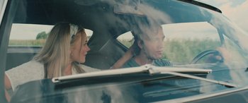 Movie still from “Pet Sematary: Bloodlines” (2023), directed by Lindsey Anderson Beer – A man and a woman sitting in the back of a car; Close Up shot, Over the shoulder angle