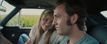 Movie still from “Pet Sematary: Bloodlines” (2023), directed by Lindsey Anderson Beer – A man and a woman sitting in the back of a car; Close Up shot, Over the shoulder angle