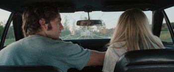 Movie still from “Pet Sematary: Bloodlines” (2023), directed by Lindsey Anderson Beer – A man and a woman in the back seat of a car; Medium shot, Over the shoulder angle