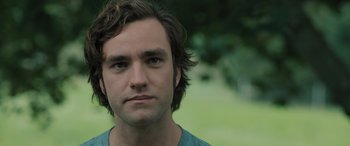 Movie still from “Pet Sematary: Bloodlines” (2023), directed by Lindsey Anderson Beer – A person with long brown hair; Close Up shot, Over the shoulder angle