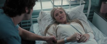 Movie still from “Pet Sematary: Bloodlines” (2023), directed by Lindsey Anderson Beer – A woman laying in a hospital bed next to a man; Close Up shot, Over the shoulder angle