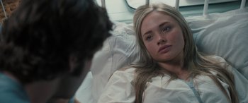 Movie still from “Pet Sematary: Bloodlines” (2023), directed by Lindsey Anderson Beer – A woman laying in a hospital bed looking at a man; Close Up shot, Over the shoulder angle