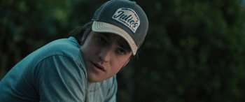 Movie still from “Pet Sematary: Bloodlines” (2023), directed by Lindsey Anderson Beer – A young man wearing a baseball cap and a jacket; Close Up shot, Over the shoulder angle