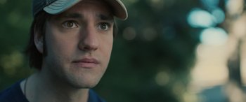 Movie still from “Pet Sematary: Bloodlines” (2023), directed by Lindsey Anderson Beer – A person wearing a hat; Close Up shot, Low angle