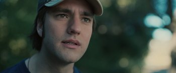 Movie still from “Pet Sematary: Bloodlines” (2023), directed by Lindsey Anderson Beer – A person wearing a hat; Close Up shot, Over the shoulder angle