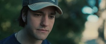 Movie still from “Pet Sematary: Bloodlines” (2023), directed by Lindsey Anderson Beer – A person wearing a hat; Close Up shot, Over the shoulder angle