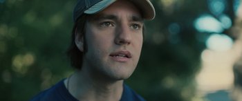 Movie still from “Pet Sematary: Bloodlines” (2023), directed by Lindsey Anderson Beer – A person wearing a hat; Close Up shot, Low angle
