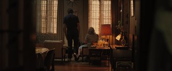 Movie still from “Pet Sematary: Bloodlines” (2023), directed by Lindsey Anderson Beer – A man and a woman sitting on a chair in a living room; Wide shot, Over the shoulder angle