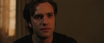 Movie still from “Pet Sematary: Bloodlines” (2023), directed by Lindsey Anderson Beer – A person looking at the camera; Close Up shot, Over the shoulder angle