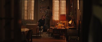 Movie still from “Pet Sematary: Bloodlines” (2023), directed by Lindsey Anderson Beer – Two men are sitting in a living room; Wide shot, Over the shoulder angle