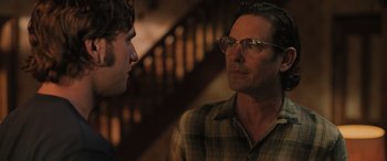 Movie still from “Pet Sematary: Bloodlines” (2023), directed by Lindsey Anderson Beer – A man wearing glasses talking to another man; Close Up shot, Over the shoulder angle