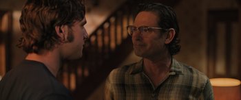 Movie still from “Pet Sematary: Bloodlines” (2023), directed by Lindsey Anderson Beer – A man wearing glasses talking to another man; Close Up shot, Over the shoulder angle