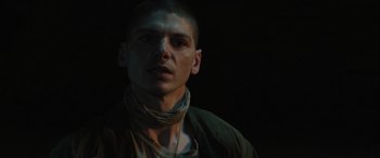 Movie still from “Pet Sematary: Bloodlines” (2023), directed by Lindsey Anderson Beer – A man with a beard is wearing a neck scarf; Close Up shot, Low angle