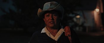 Movie still from “Pet Sematary: Bloodlines” (2023), directed by Lindsey Anderson Beer – A woman wearing a cowboy hat and holding an object in her hand; Close Up shot, Low angle