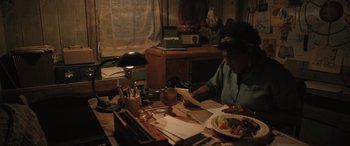 Movie still from “Pet Sematary: Bloodlines” (2023), directed by Lindsey Anderson Beer – A person sitting at a table with a plate of food; Medium shot, High angle