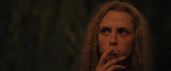 Movie still from “Pet Sematary: Bloodlines” (2023), directed by Lindsey Anderson Beer – A person smoking a cigarette; Close Up shot, Low angle