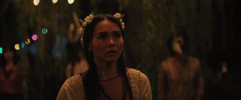 Movie still from “Pet Sematary: Bloodlines” (2023), directed by Lindsey Anderson Beer – A woman wearing a flower crown looking to her left; Close Up shot, Over the shoulder angle
