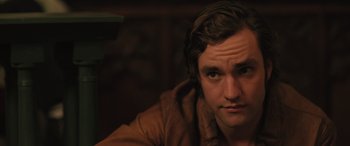 Movie still from “Pet Sematary: Bloodlines” (2023), directed by Lindsey Anderson Beer – A person wearing a brown jacket; Close Up shot, Over the shoulder angle