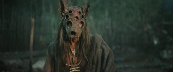 Movie still from “Pet Sematary: Bloodlines” (2023), directed by Lindsey Anderson Beer – A man with a mask and a long beard; Close Up shot, Over the shoulder angle