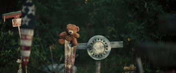 Movie still from “Pet Sematary: Bloodlines” (2023), directed by Lindsey Anderson Beer – A teddy bear sitting on top of a pole; Extreme Close Up shot, High angle