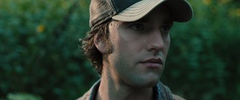 Movie still from “Pet Sematary: Bloodlines” (2023), directed by Lindsey Anderson Beer – A person wearing a hat; Close Up shot, Low angle