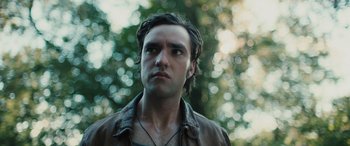 Movie still from “Pet Sematary: Bloodlines” (2023), directed by Lindsey Anderson Beer – A person wearing a brown jacket; Close Up shot, Low angle