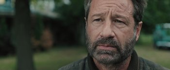 Movie still from “Pet Sematary: Bloodlines” (2023), directed by Lindsey Anderson Beer – A person with a beard; Close Up shot, Over the shoulder angle