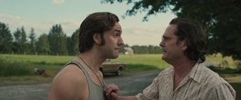 Movie still from “Pet Sematary: Bloodlines” (2023), directed by Lindsey Anderson Beer – Two men standing next to each other on a field; Close Up shot, Over the shoulder angle