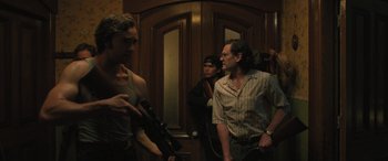 Movie still from “Pet Sematary: Bloodlines” (2023), directed by Lindsey Anderson Beer – A group of men standing next to each other in front of a door; Medium shot, Over the shoulder angle