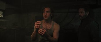 Movie still from “Pet Sematary: Bloodlines” (2023), directed by Lindsey Anderson Beer – A young man holding a cell phone in his hands; Close Up shot, Low angle