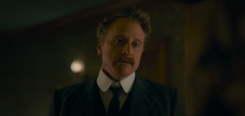 Movie still from “Peter Pan & Wendy” (2023), directed by David Lowery – A person wearing a suit and tie; Close Up shot, Low angle