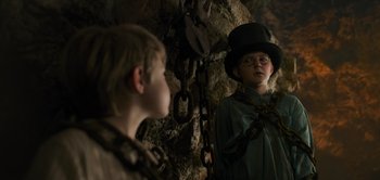 Movie still from “Peter Pan & Wendy” (2023), directed by David Lowery – Two children in a cave looking at each other; Medium shot, Over the shoulder angle