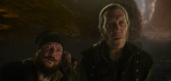 Movie still from “Peter Pan & Wendy” (2023), directed by David Lowery – Two men standing next to each other in the dark; Close Up shot, Low angle