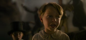 Movie still from “Peter Pan & Wendy” (2023), directed by David Lowery – A young boy with a surprised look on his face; Close Up shot, Low angle