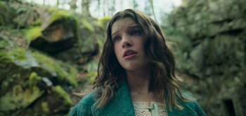 Movie still from “Peter Pan & Wendy” (2023), directed by David Lowery – A young girl with long hair looking up at the sky; Close Up shot, Low angle