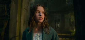 Movie still from “Peter Pan & Wendy” (2023), directed by David Lowery – A young girl with long brown hair wearing a green jacket; Close Up shot, Low angle