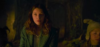 Movie still from “Peter Pan & Wendy” (2023), directed by David Lowery – A young girl is sitting in a chair in a dark room; Close Up shot, High angle