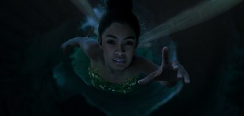 Movie still from “Peter Pan & Wendy” (2023), directed by David Lowery – A woman in a green dress swimming in a body of water at night; Close Up shot, Overhead angle